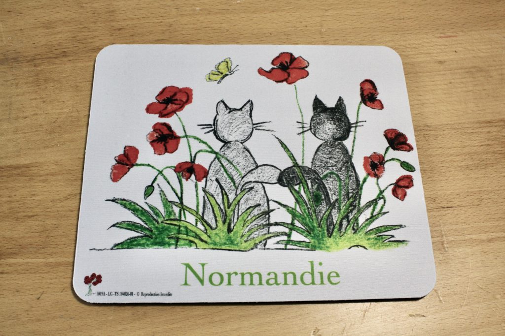 Mouse pad illustrated with two cats in a field of poppies, with the word "Normandy" at the bottom.